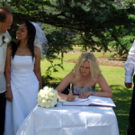 The happy couple wait for their witness to sign the register